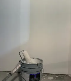 Commercial paint bucket and roller on a job site