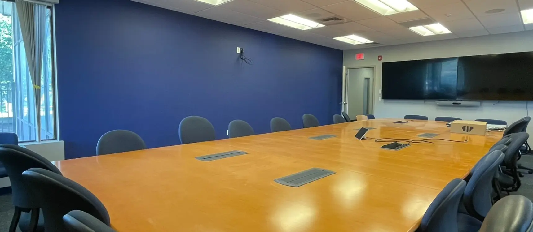 Conference room repainted with a navy accent wall