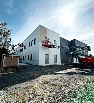 New commercial building exterior painted from a lift