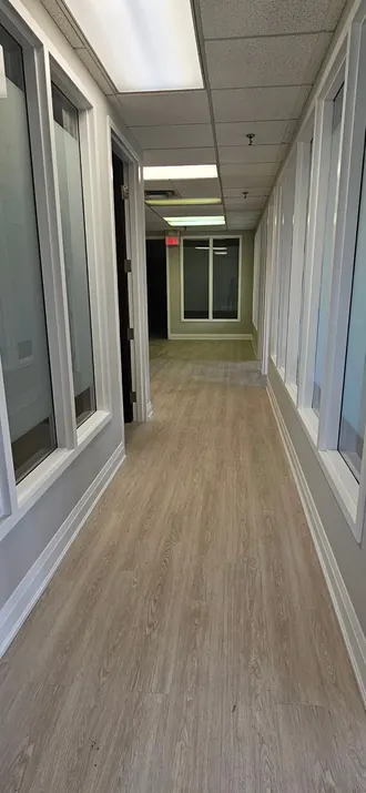 Repainted office corridor with glass walls