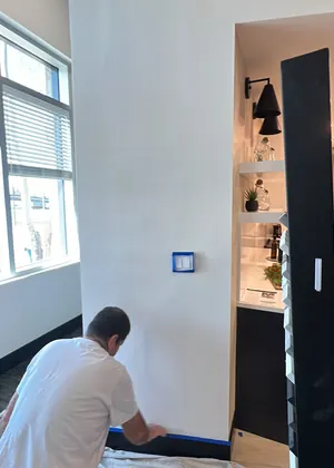 Painter cutting in an office wall in Frisco